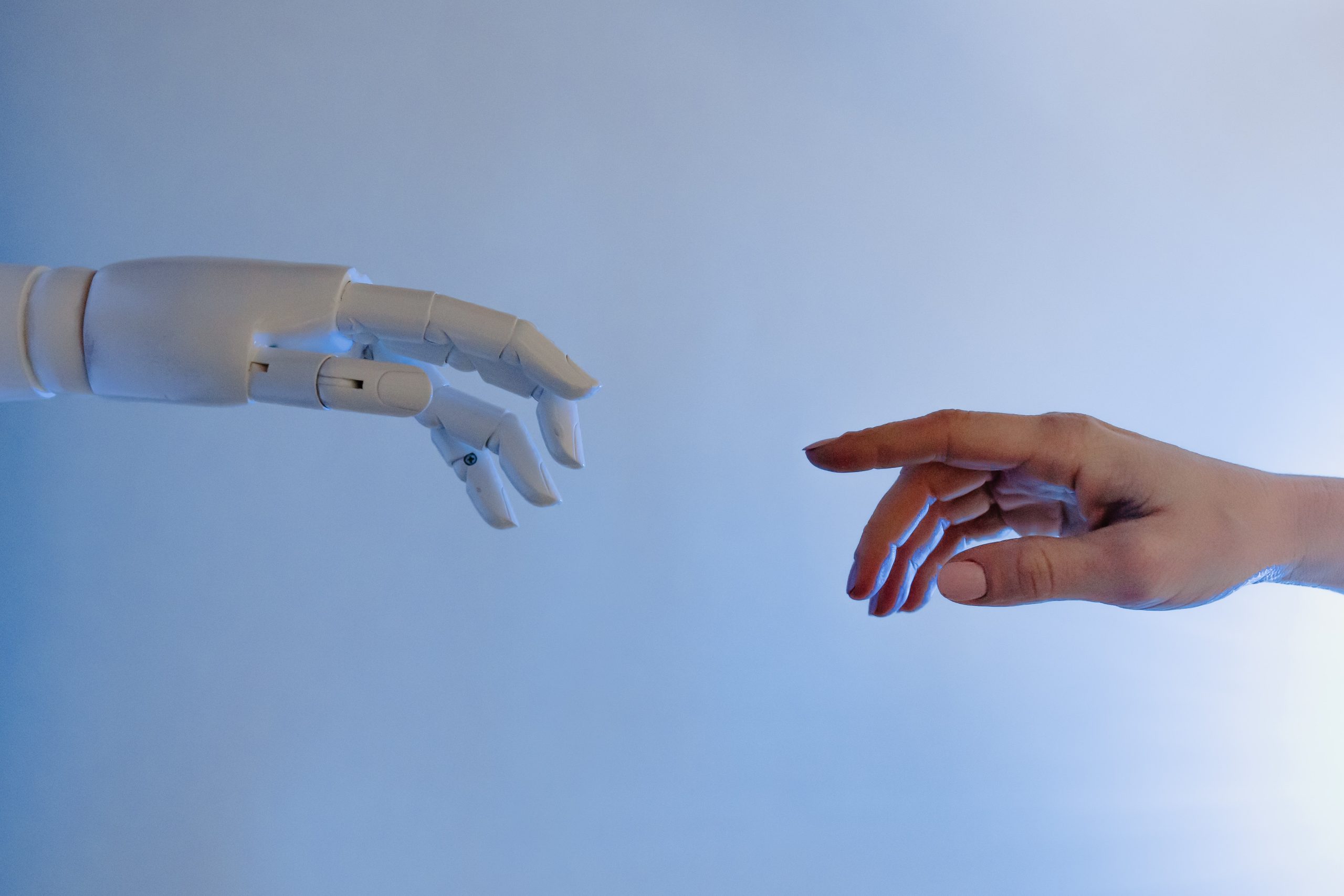 automation - robot and human finger